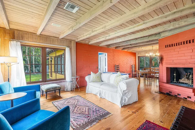 a view of a dining room with furniture a chandelier and wooden floor