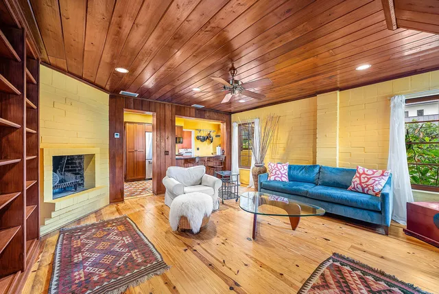 a spacious bedroom with a bed and wooden floor