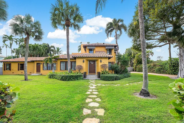 a front view of a house with a garden