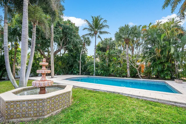 a living room with furniture a large window and flat screen tv