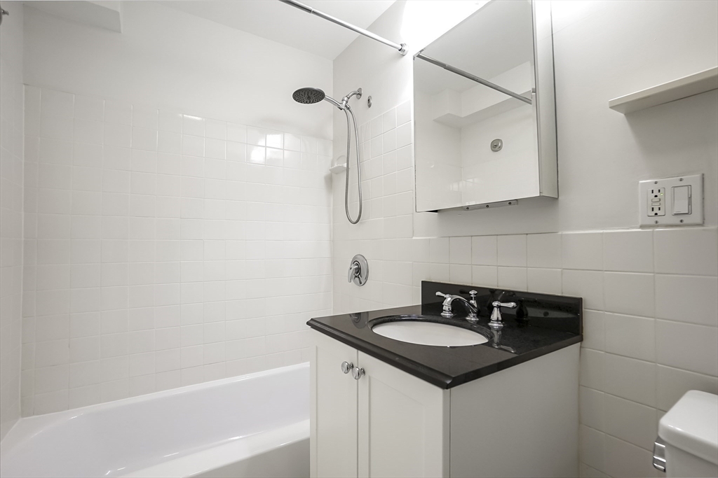1600 Beacon Street, Unit 607 Brookline, MA 02446 - Photo 8 of 11 a bathroom with a sink and a mirror