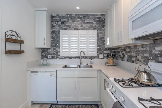 a kitchen with a sink stove and cabinets