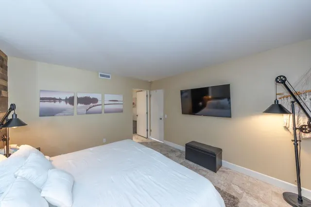 a bedroom with a bed and a flat screen tv