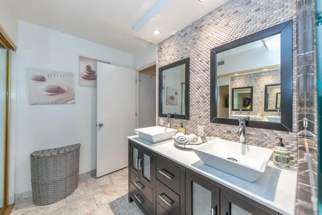 a bathroom with a double vanity sink and a mirror