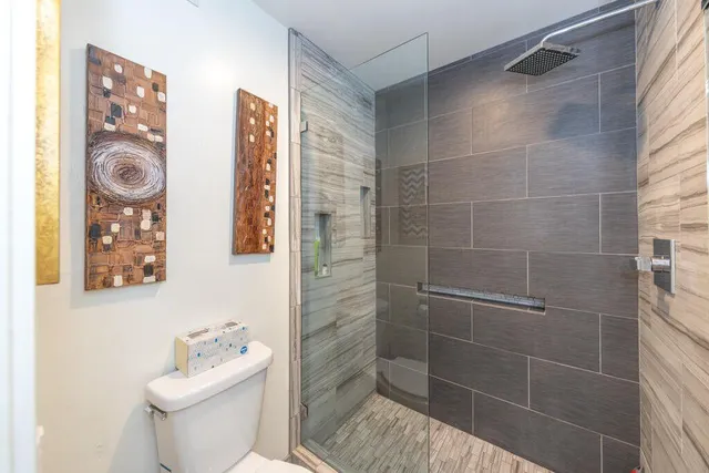 a bathroom with a toilet and shower