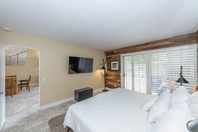 a bedroom with a bed and a television