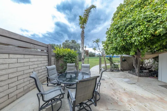 a view of a patio with table and chairs and potted plants