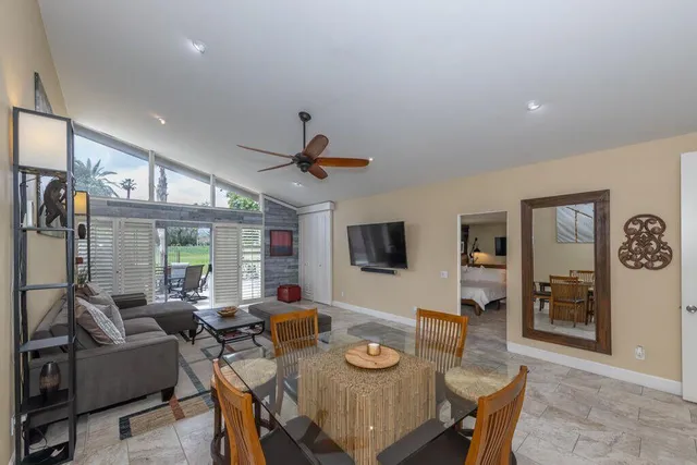 a view of a livingroom with furniture and a flat screen tv