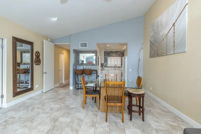 a dining room with furniture and wooden floor