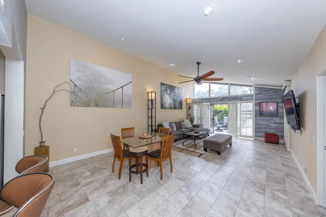 a living room with furniture a window and gym equipment
