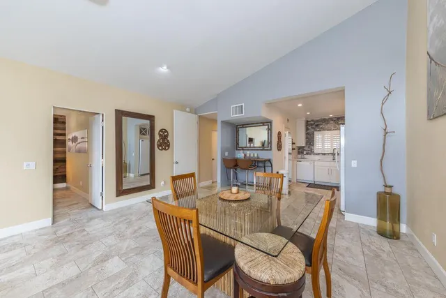 a dining room with furniture and window