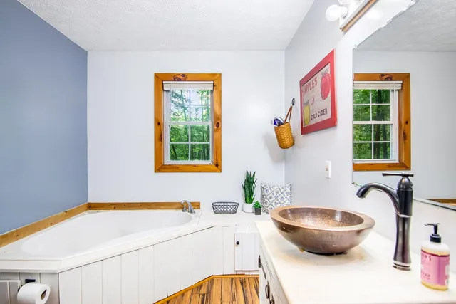 a bathroom with a toilet and a potted plant