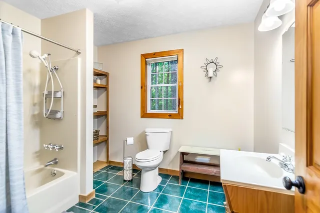 a bathroom with a shower and a sink