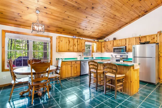 a kitchen with stainless steel appliances granite countertop a refrigerator and a stove top oven