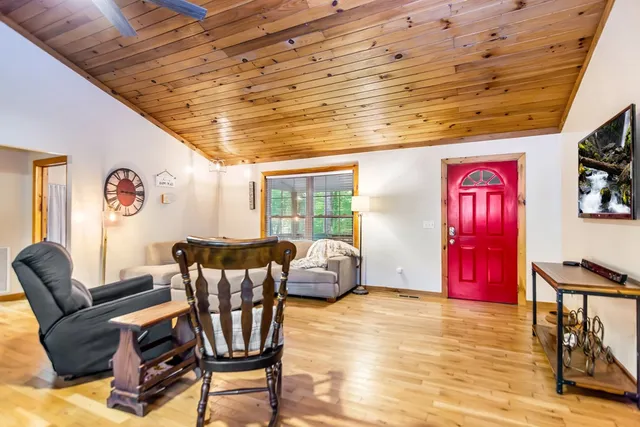 a dining table with chairs and kitchen view