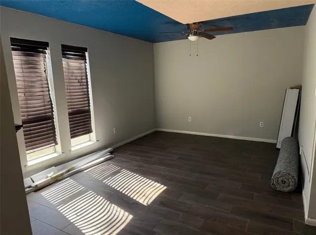 a view of a closet area with wooden floor