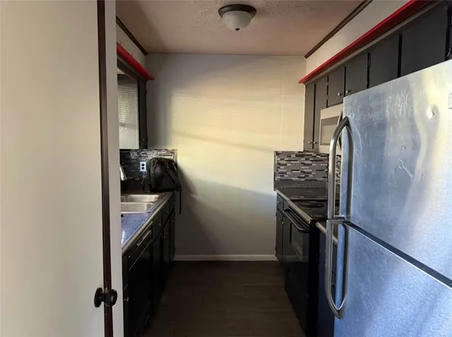 a kitchen with a refrigerator and a stove