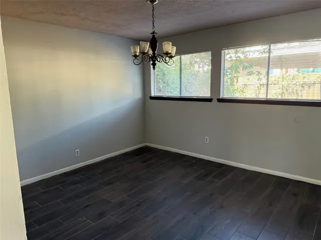 a view of a room with wooden floor and windows