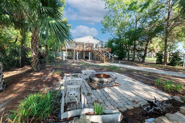 a view of a house with a yard and sitting area