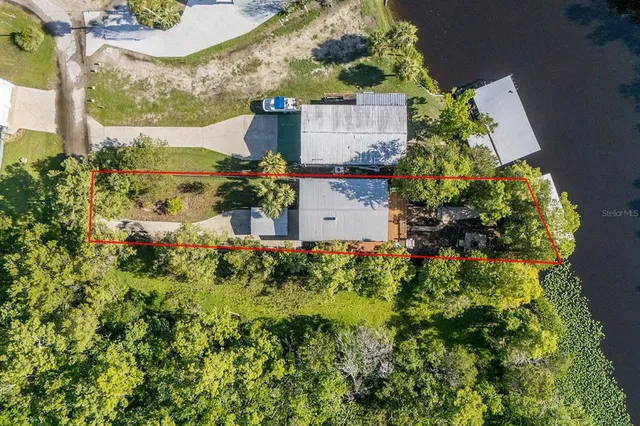 an aerial view of a house with a yard