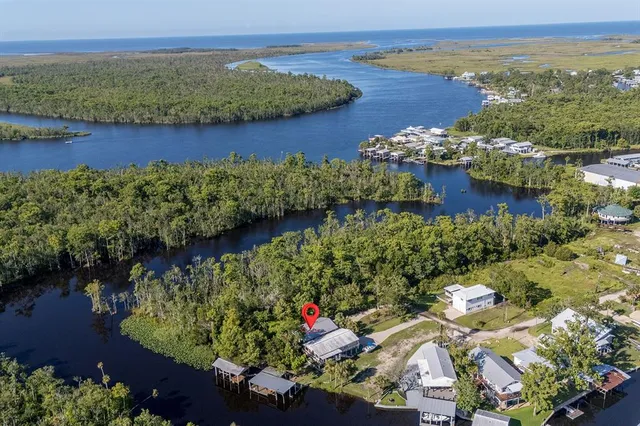 an aerial view of a house with a lake view