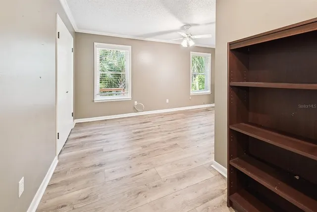 an empty room with wooden floor and closet