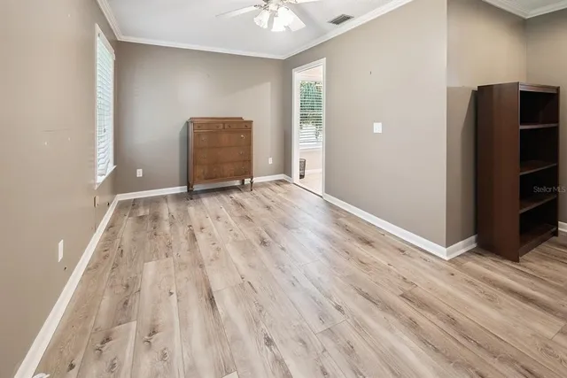 wooden floor in an empty room with a window