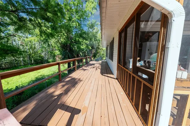 a view of balcony with wooden floor and fence