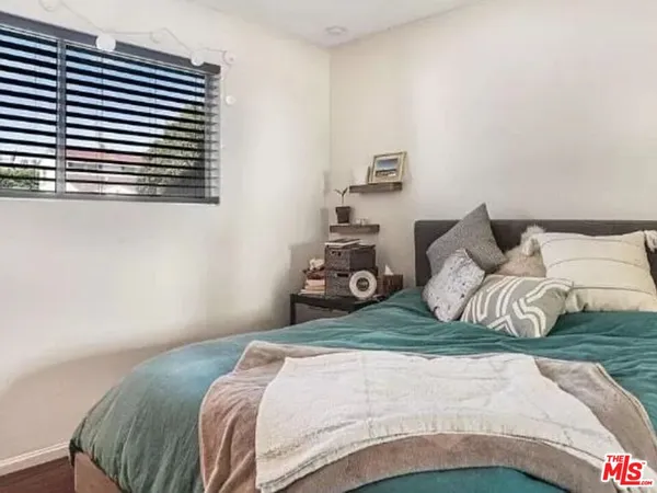 a bedroom with a bed and a night stand
