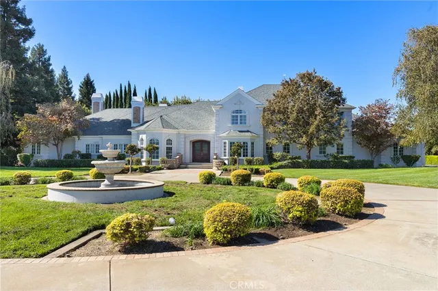 a front view of a house with swimming pool garden and outdoor seating