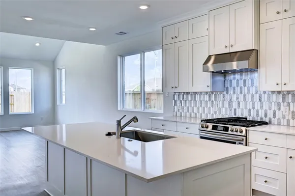 a kitchen that has a sink and a stove