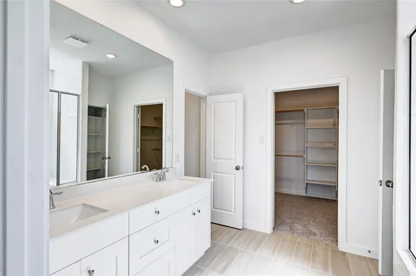 a bathroom with a double vanity sink and mirror