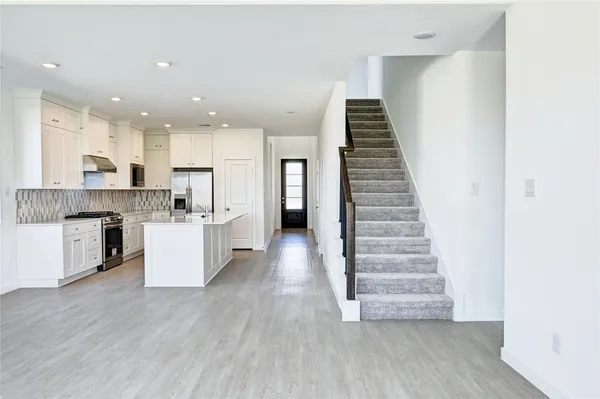 a view of kitchen with cabinets and wooden floor