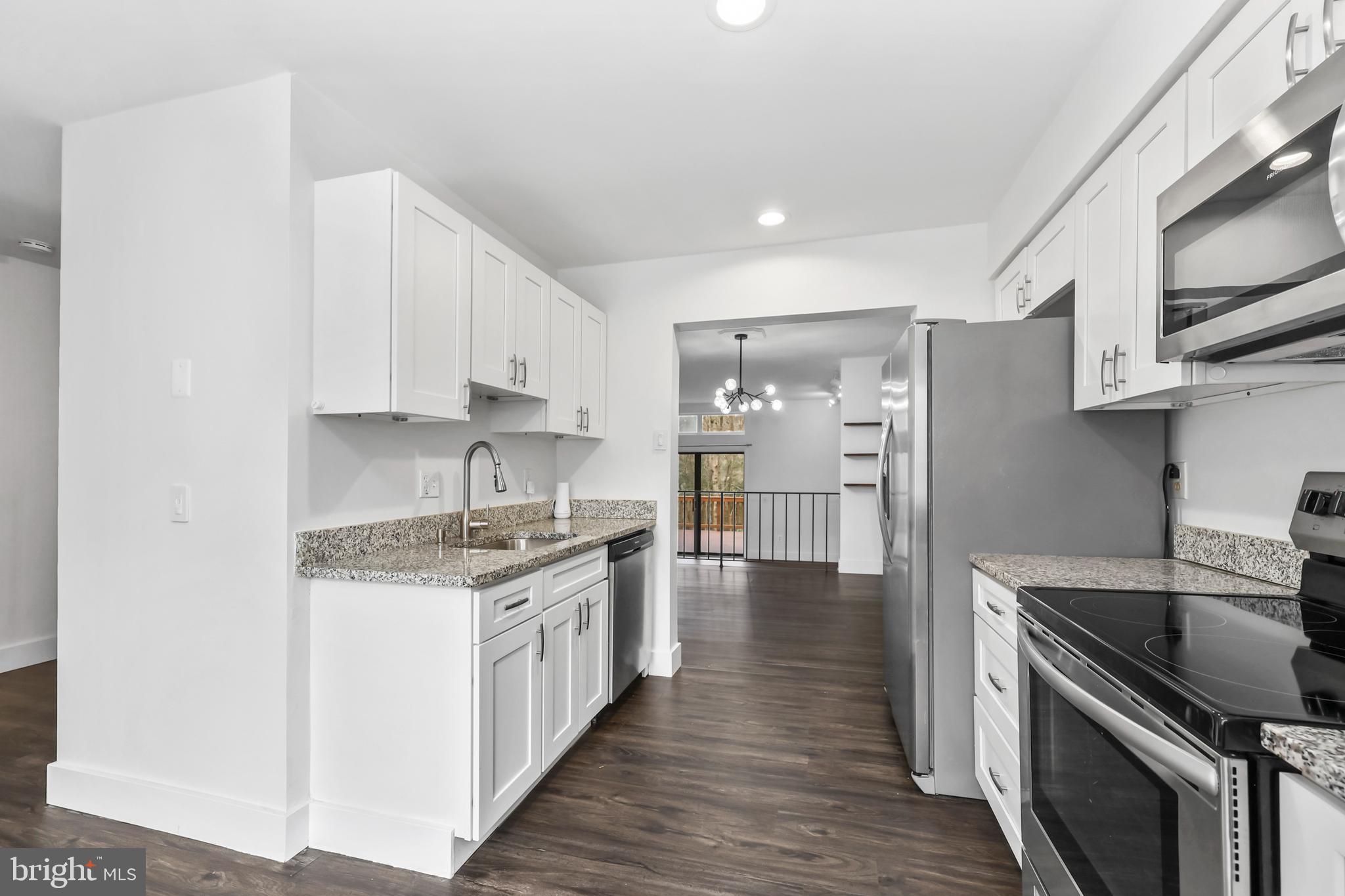 11711 Decade Court Reston, VA 20191 - Photo 5 of 44 a kitchen with stainless steel appliances granite countertop a stove and a refrigerator