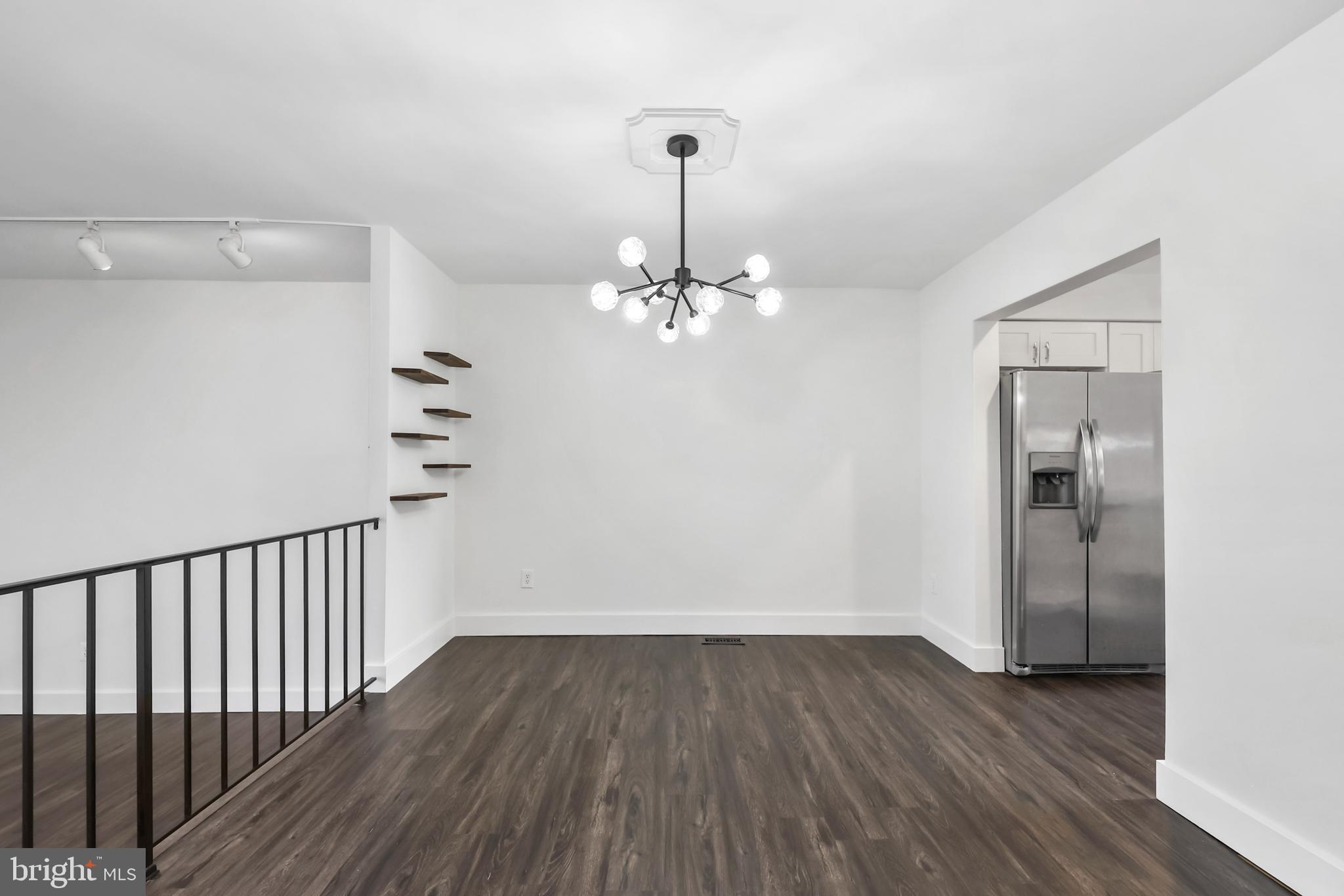 11711 Decade Court Reston, VA 20191 - Photo 8 of 44 a view of a room with wooden floor chandelier and windows