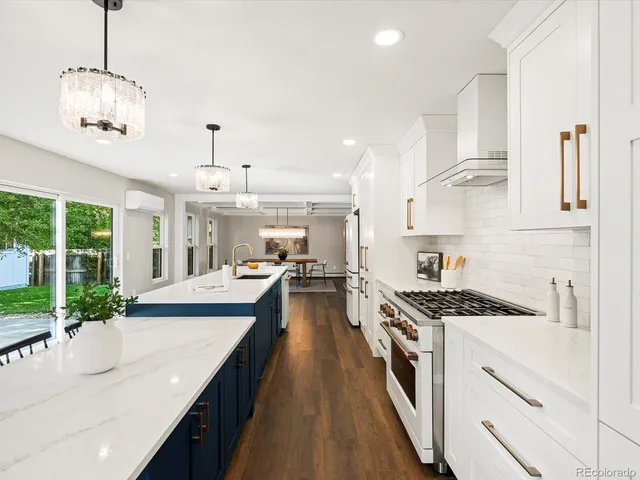 a kitchen with white cabinets and window