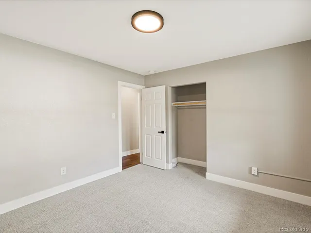 a bathroom with a toilet a sink and a mirror