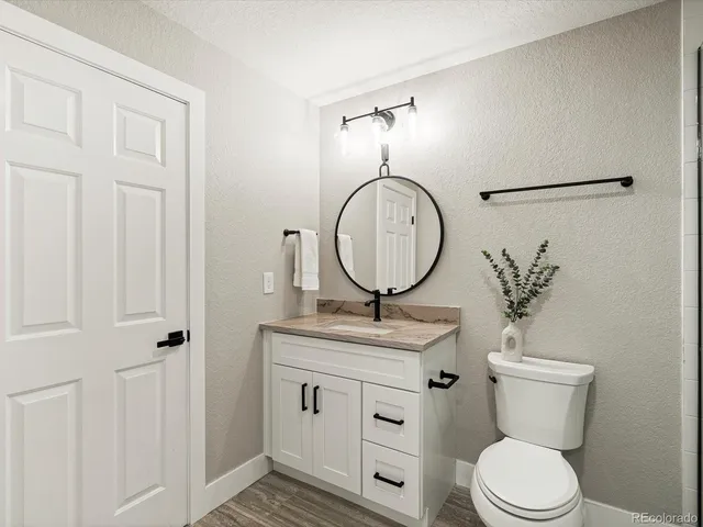 a spacious bathroom with double vanity two mirror and a bathtub