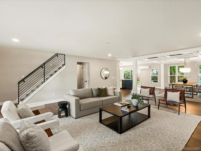a living room with fireplace furniture and a wooden floor