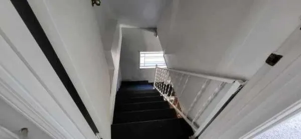 a view of staircase with wooden floor and white walls