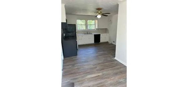 a view of a kitchen with a sink and a window