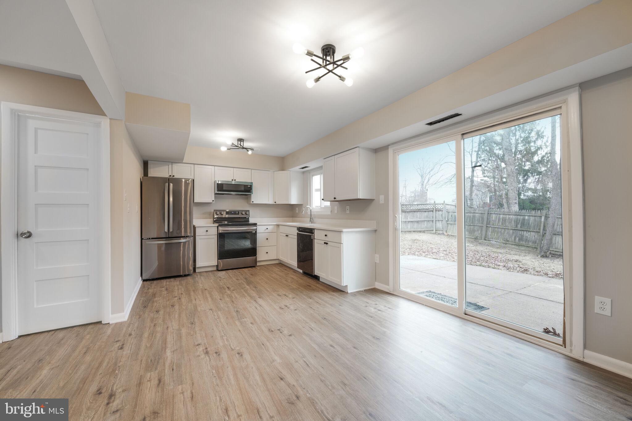 5943 Hall Street Springfield, VA 22152 - Photo 5 of 23 a kitchen with a refrigerator and a stove top oven