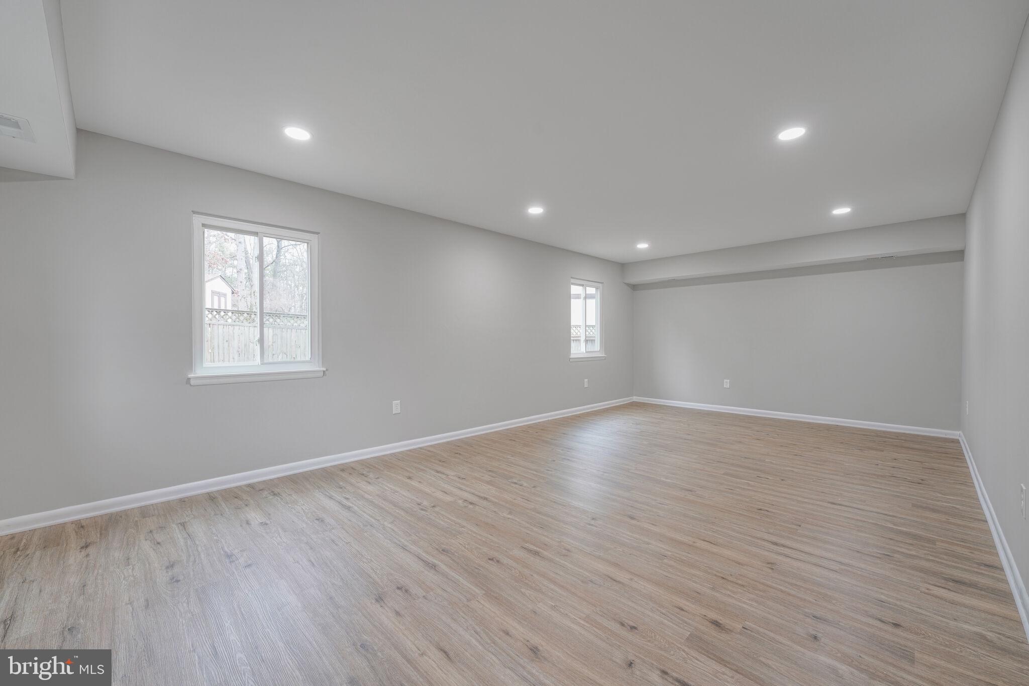 5943 Hall Street Springfield, VA 22152 - Photo 7 of 23 a view of an empty room with wooden floor and window