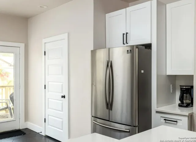 a white refrigerator freezer sitting inside of a kitchen