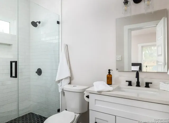 a bathroom with a sink toilet and shower