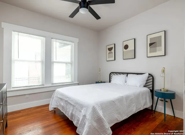 a bedroom with a bed window and a table