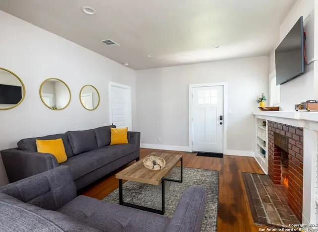 a living room with furniture and a fireplace