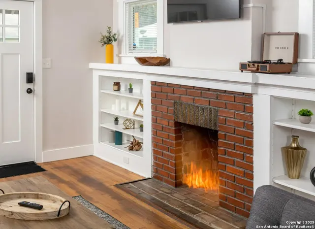a kitchen with a wooden floor and a fireplace