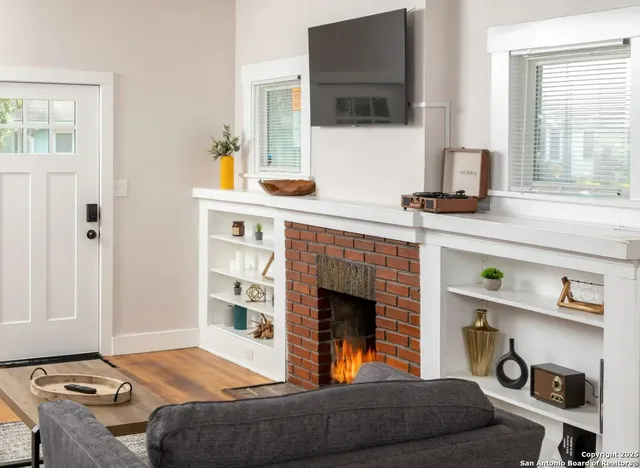 a living room with furniture and a fireplace