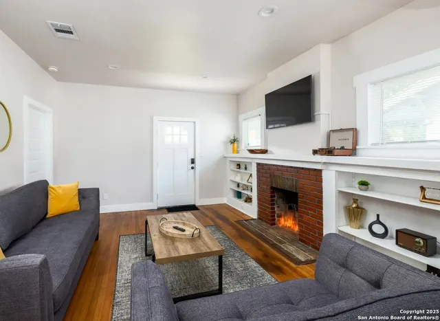 a living room with furniture and a flat screen tv